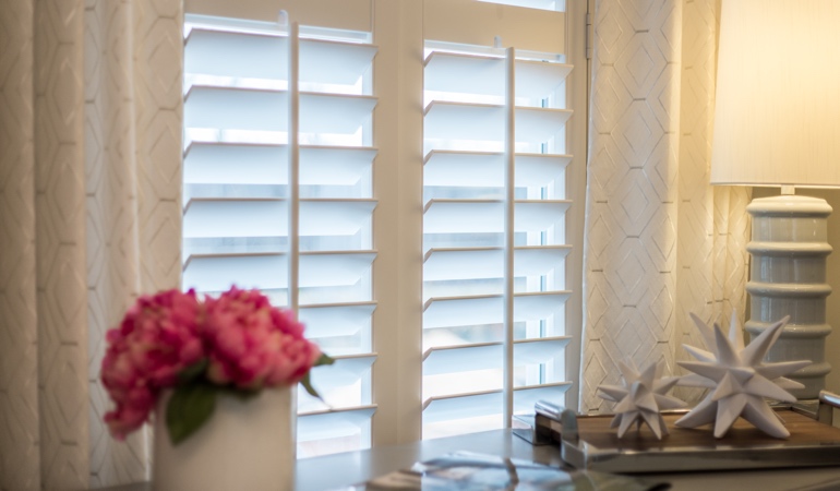 Plantation shutters by flowers in New York